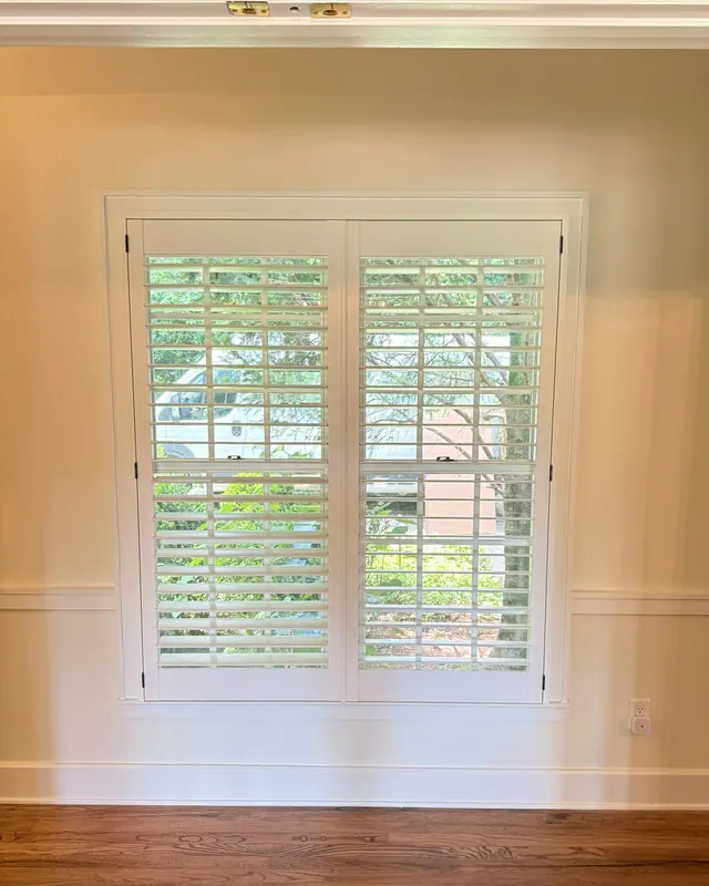 Plantation shutters with a divider rail on a double window