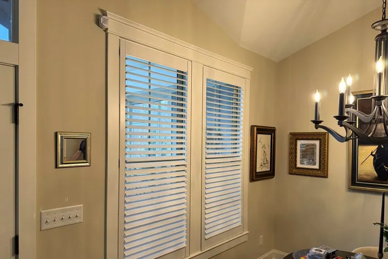 Plantation shutters with a divider rail on tall dining room windows
