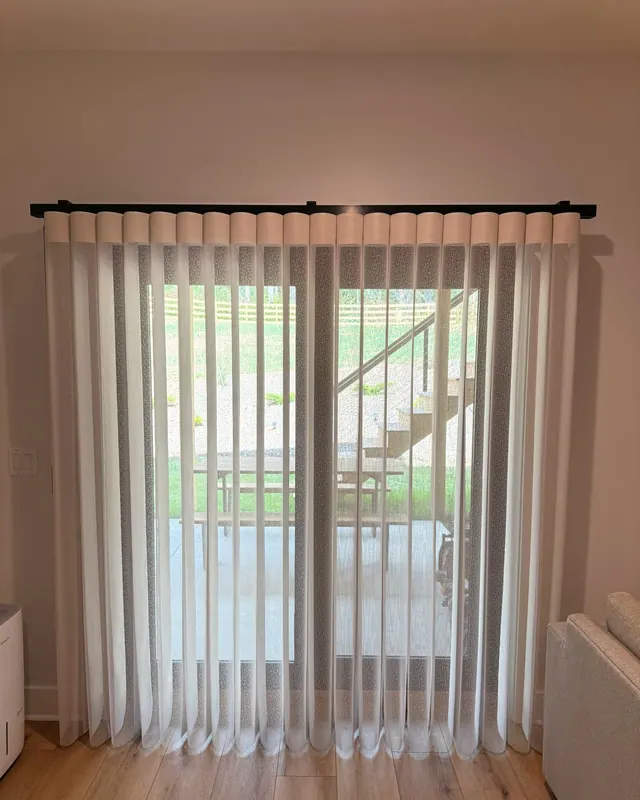SmartDrape vanes drawn across a patio door with the yard visible through them